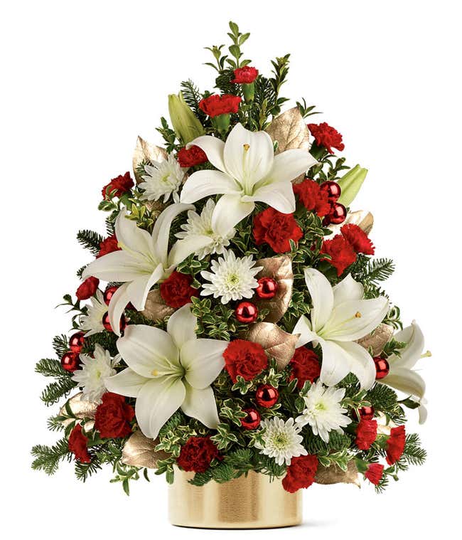 A flower Christmas tree with white and red flowers in a gold vase